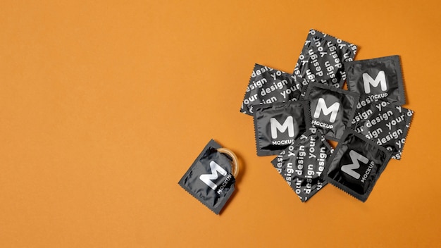 Flat lay condoms on orange background