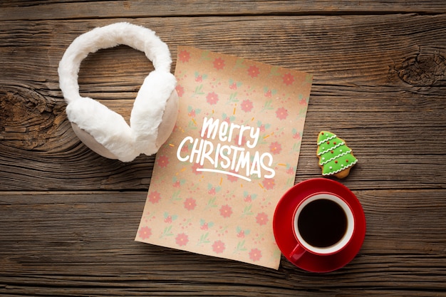 Flat lay cup of coffee with merry christmas letter