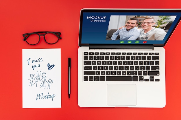 Flat lay of desk surface with laptop and pen