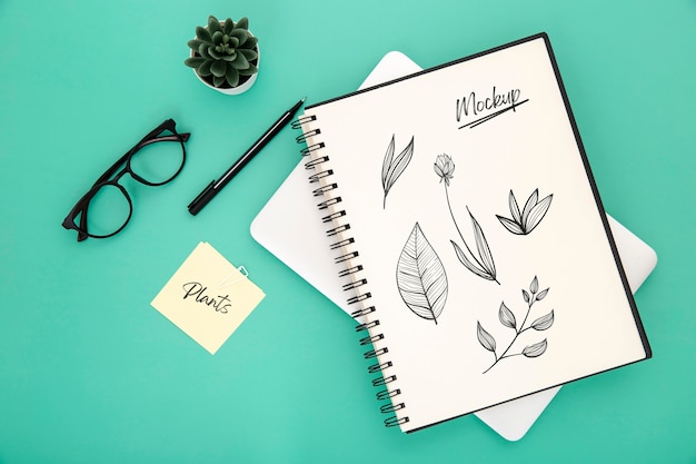 Flat lay of desk surface with notebook and pen