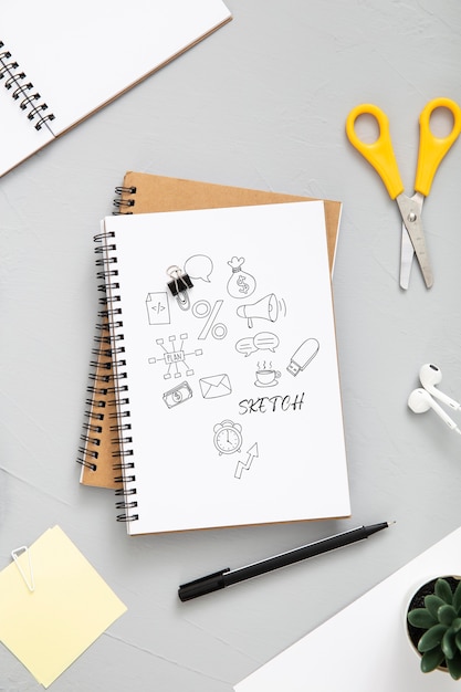 Flat lay of desk surface with scissors and notepad