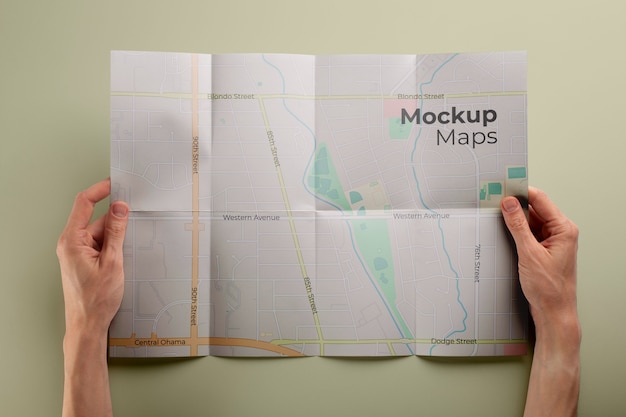 Flat lay hands holding map mockup