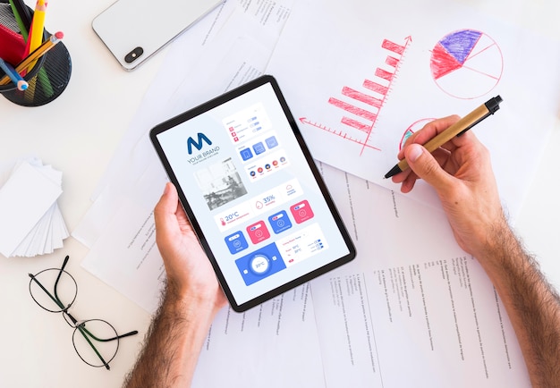 Flat lay of person holding business tablet