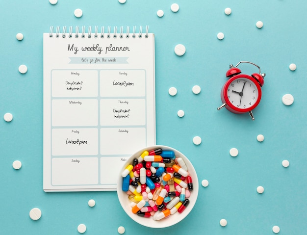 PSD flat lay pills and notebook arrangement