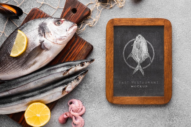 Flat lay sea food arrangement with blackboard mock-up