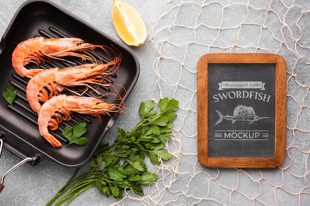 Flat lay sea food composition with blackboard mock-up