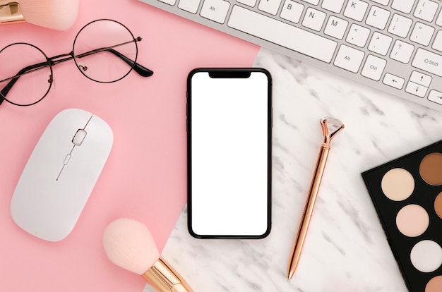 Flat lay smartphone mock-up with make-up accessories on desk