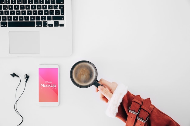 Flat lay smartphone mockup on workspace