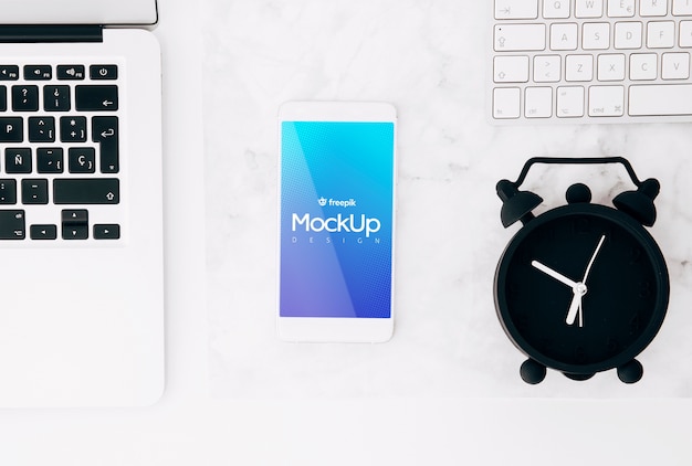 Flat lay smartphone mockup on workspace