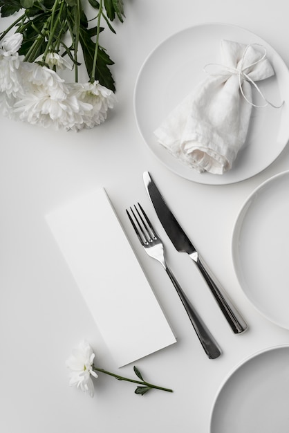 Flat lay of table arrangement with spring menu mock-up and cutlery