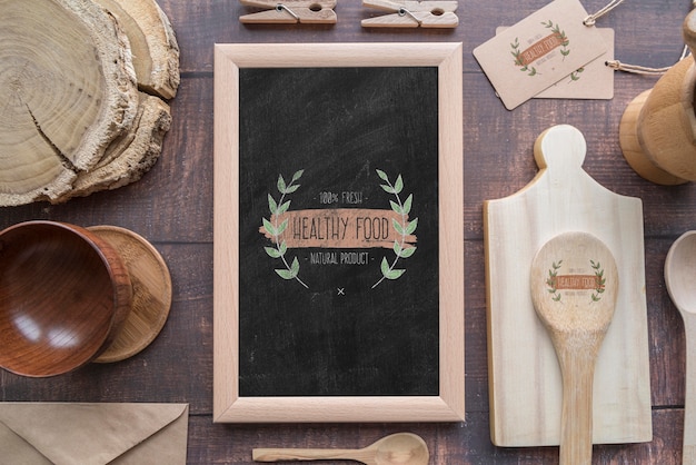 Flat lay of wooden dishes with blackboard