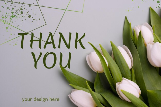 Floral background with fresh white tulips on a gray background Mockup for spring greeting card Flat lay top view