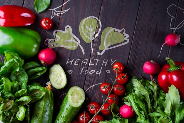 PSD frame of different health vegetables on a wooden background