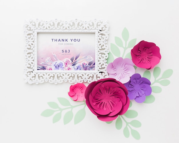 Frame mock-up with paper flowers on white background