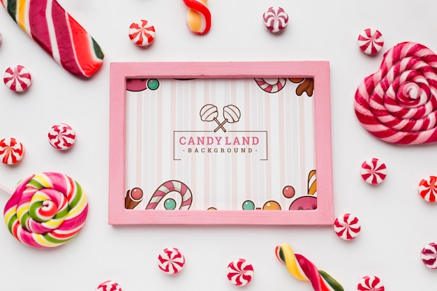 Frame with tasty candies beside