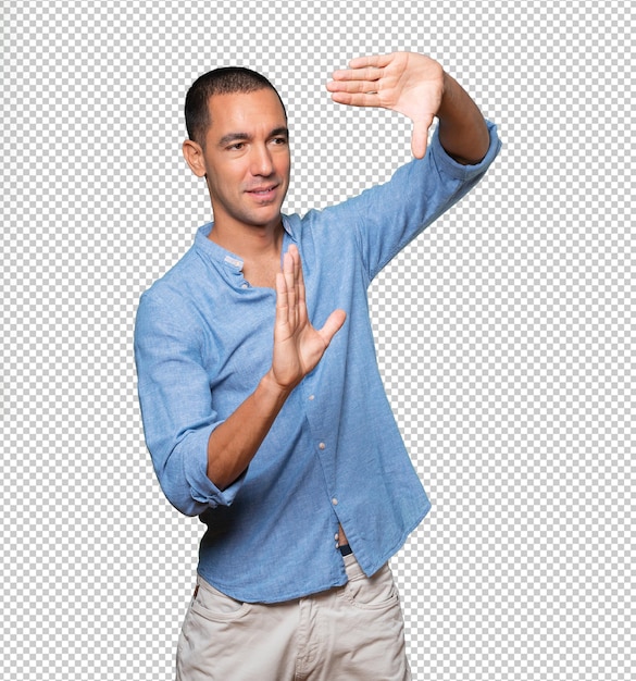 Friendly young man making a gesture of taking a photo with the hands