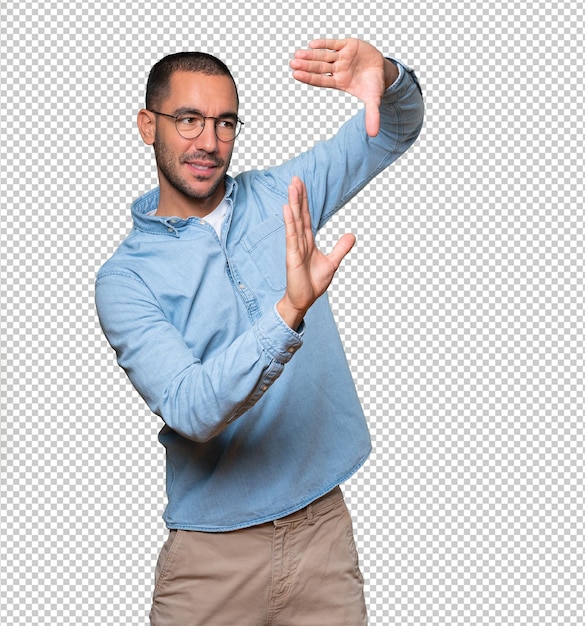 Friendly young man making a gesture of taking a photo with the hands