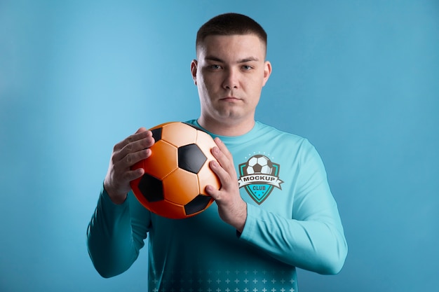 Front view man holding soccer ball