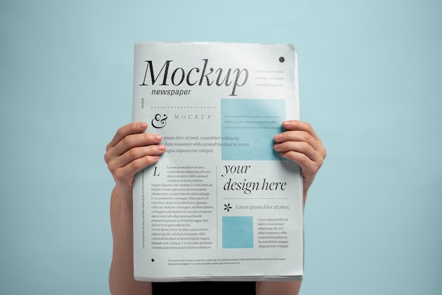 PSD front view of person holding newspaper mock-up