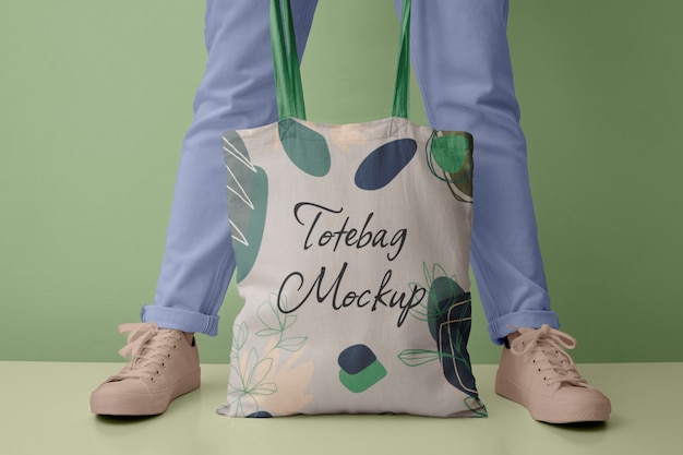 Front view of person holding tote bag mock-up