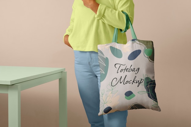 Front view of person holding tote bag mock-up