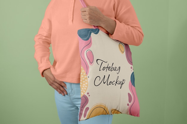 Front view of person holding tote bag mock-up