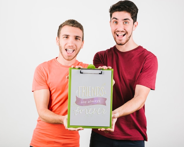 Front view smiley boys with clipboard 