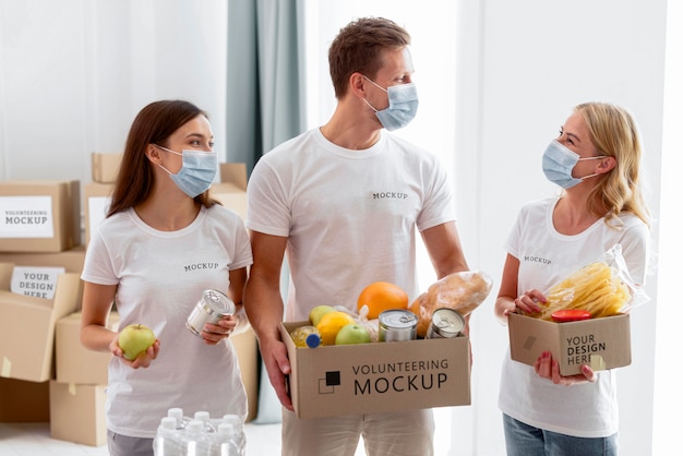 PSD front view of volunteers with medical masks preparing provision donations