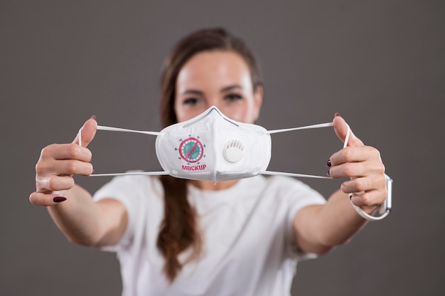 Front view of woman holding a mask