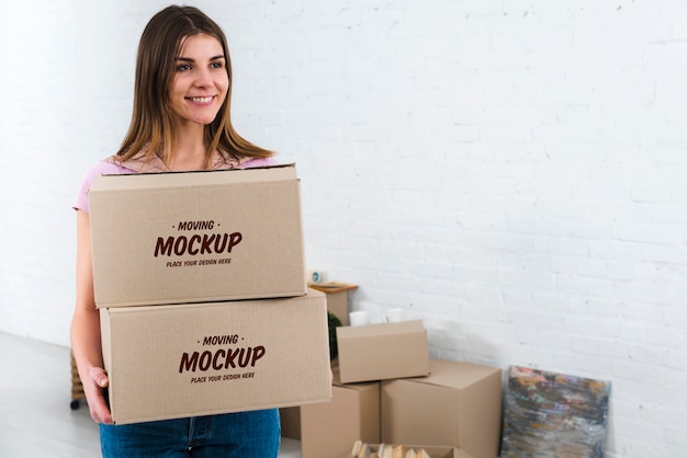 Front view of woman holding moving boxes mock-up