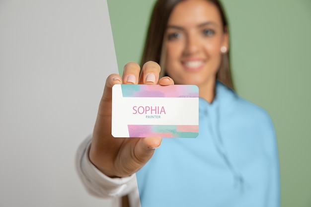 Front view of woman showing business card