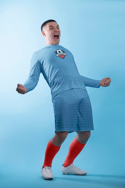 Full shot excited man wearing soccer equipment