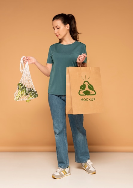 PSD full shot woman holding paper bag