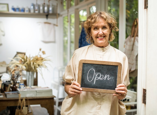 PSD garden shop owner holding an open sign