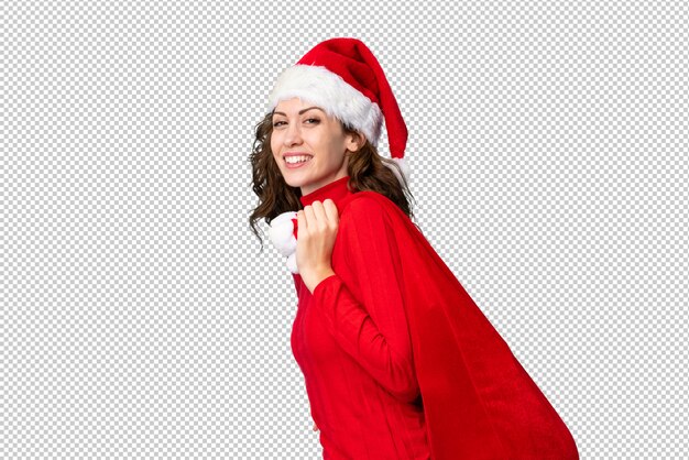 PSD girl with christmas hat holding a christmas bag full of gifts