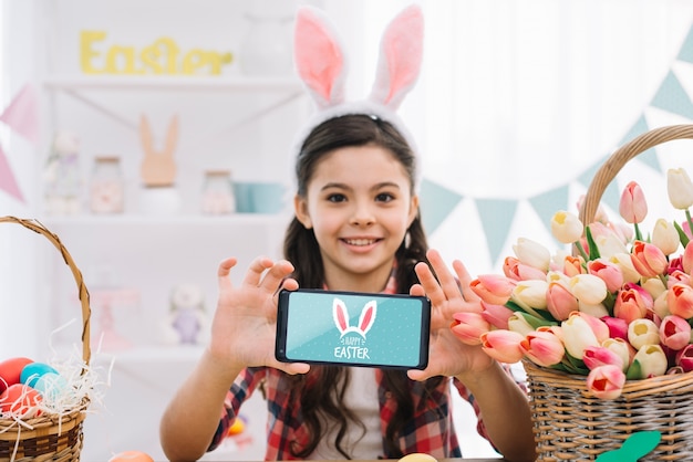 Girl with smartphone mockup on easter day