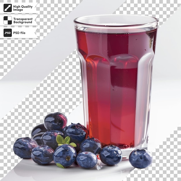 a glass of red liquid next to blueberries