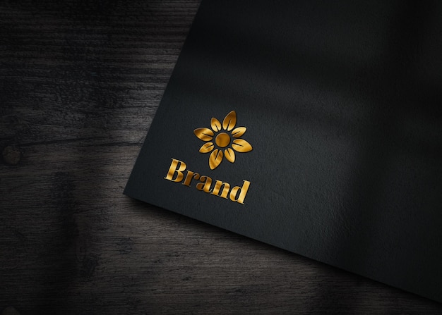 Golden logo mockup embossed on black paper Premium Psd