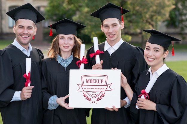 PSD graduates holding proudly a mock-up diploma