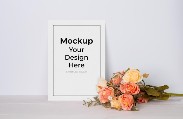 Greeting card mockup and flower on wooden table