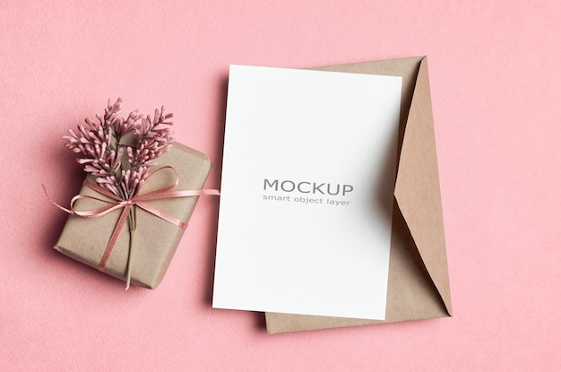 Greeting card mockup with envelope and gift box with flowers