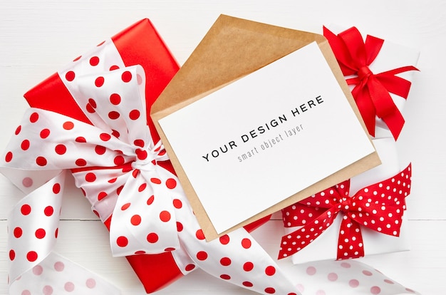 Greeting card mockup with envelope and gift boxes with red ribbons