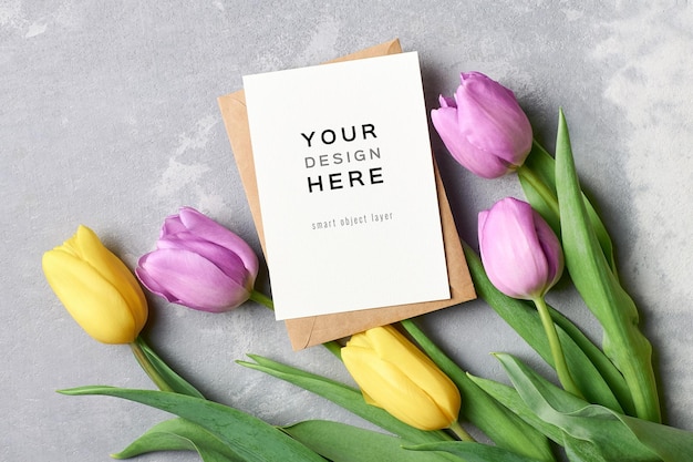 Greeting card mockup with envelope and tulip flowers on grey