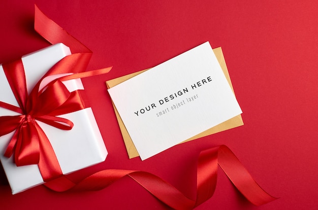 Greeting card mockup with gift box on red background