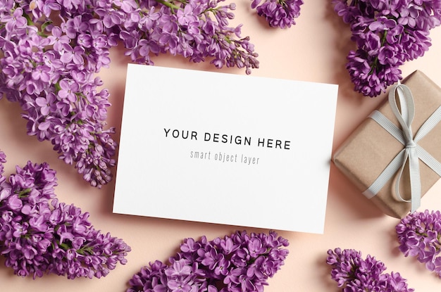 Greeting card mockup with gift box and spring lilac flowers