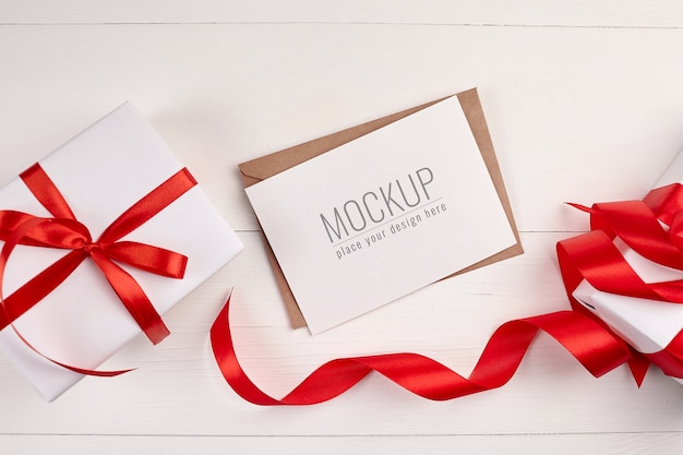 Greeting card mockup with gift boxes and red ribbon