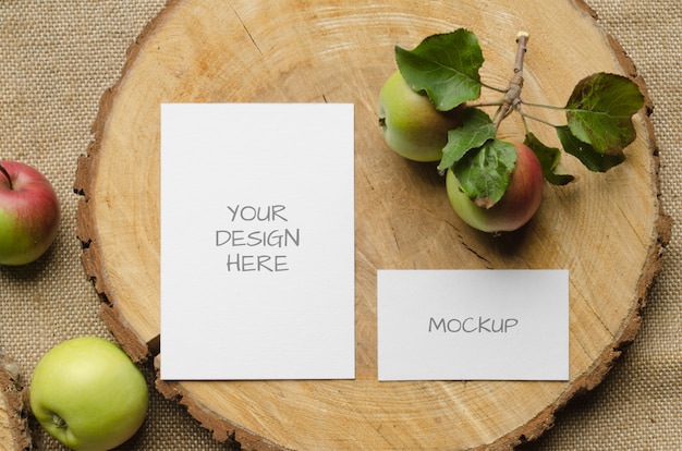 greeting card or wedding invitation mockup with with apples on a beige background in rustic style and natural