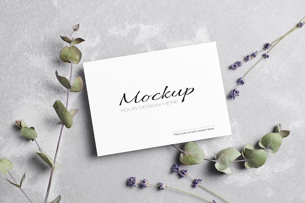 Greeting or wedding invitation card mockup with dry lavender and eucalyptus flowers