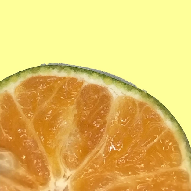 PSD a half of a half of a orange is shown on a yellow background