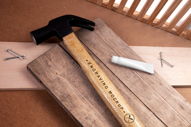 Hammer with wooden handle and engraved text effect mock-up